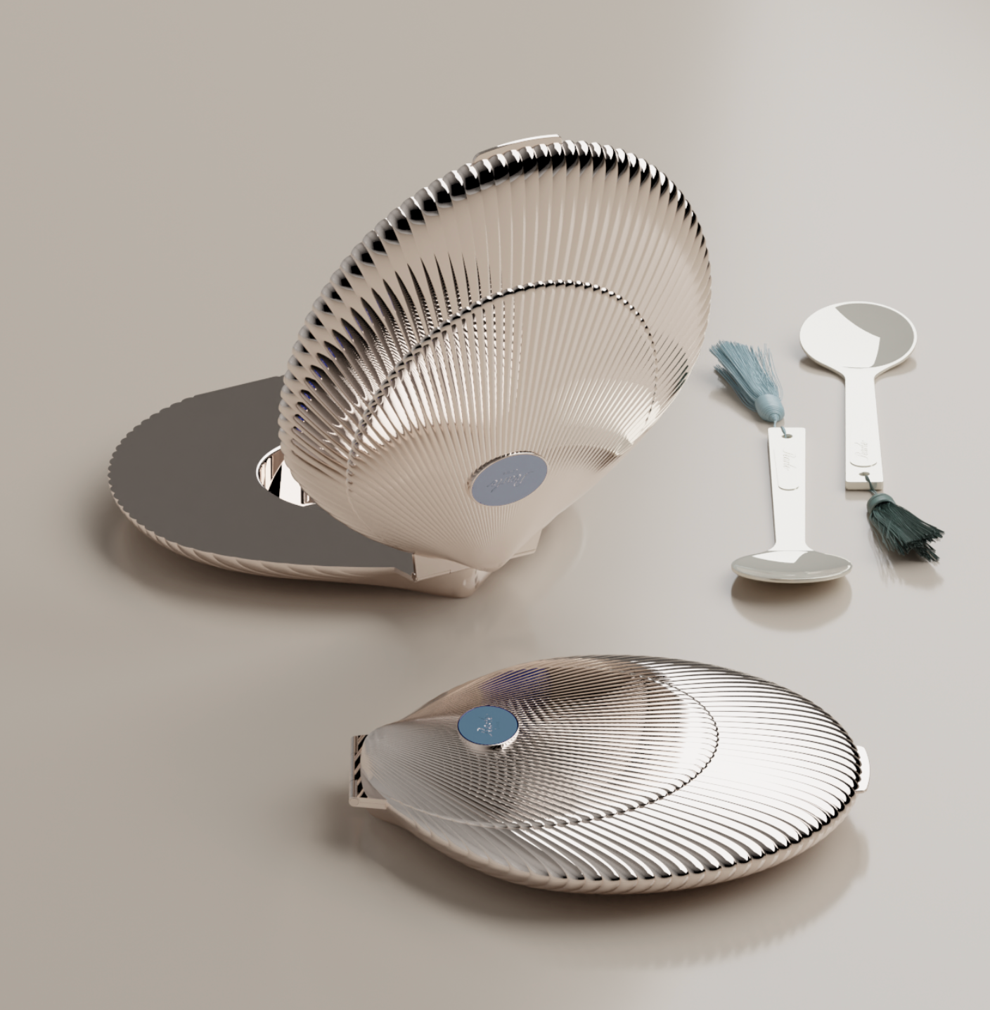 Set of silver caviar serving items including 2 decorative shells and 2 cavair spoons on a light gray background.